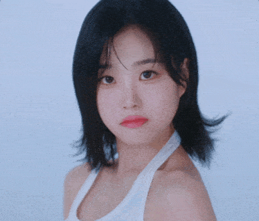 a close up of a woman 's face with a blue background