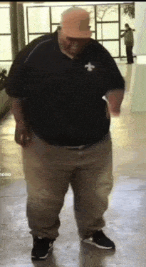 a man in a black shirt with a saints logo on it