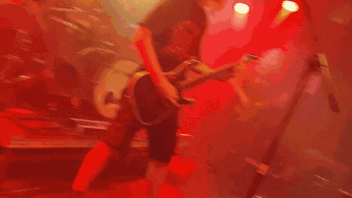 a close up of a person 's face with a red background
