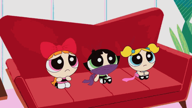 three cartoon characters sit on a red couch with one wearing a scarf around her neck