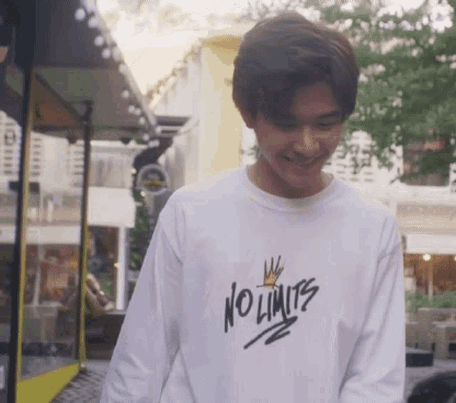 a man wearing a white shirt with the words no limits on it