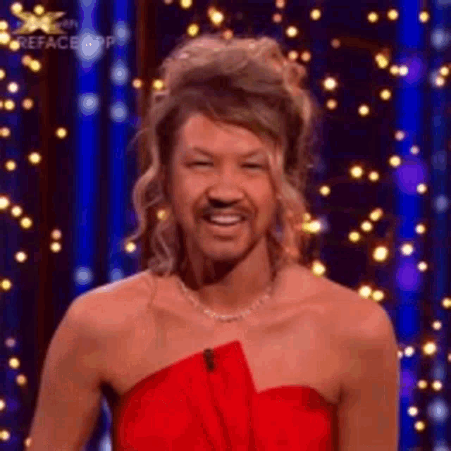 a woman in a red dress with a man 's face on her face