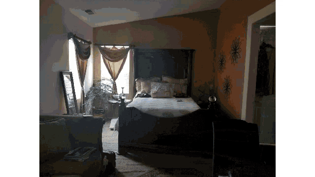 a bedroom with a bed and a mirror