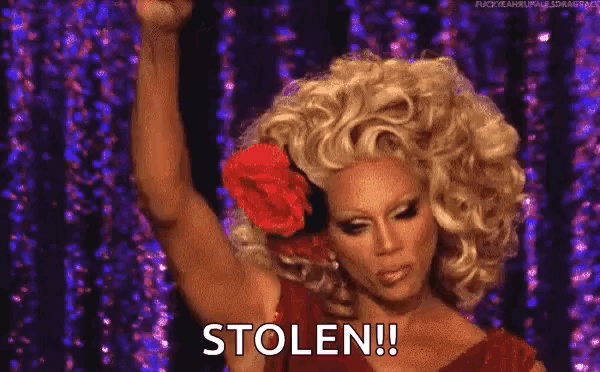 a drag queen with a rose in her hair says stolen !