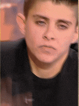 a close up of a man 's face with a black shirt on