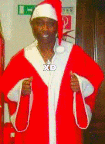 a man in a santa claus costume with a xd necklace