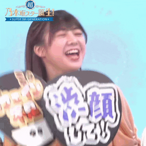 a girl holding a fan with chinese writing on it