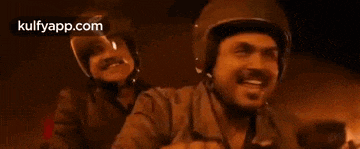 a man wearing a helmet is riding a motorcycle .