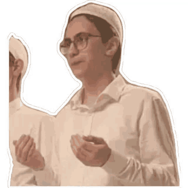 a man wearing glasses and a white hat is standing next to another man .