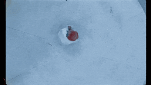 a woman with red hair is laying on a white surface looking up at something