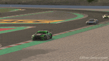 a black car is flying through the air on a track with iracing.com written on the bottom right