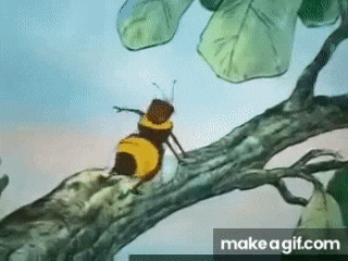 a bee is sitting on a tree branch with leaves .