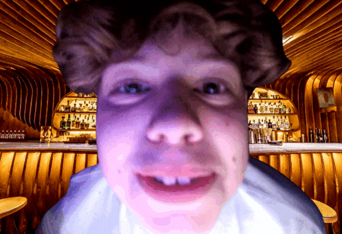 a close up of a person 's face in a bar