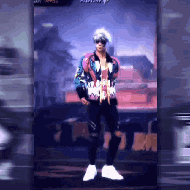 a man in a colorful jacket and jeans is standing in front of a sign that says playing
