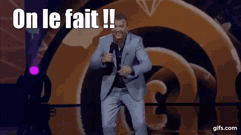 a man in a suit is dancing on a stage with the words on le fait in the background