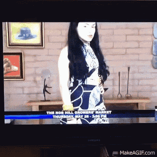 a tv screen shows a woman standing in front of a brick wall and the words " the nor hill growers market "