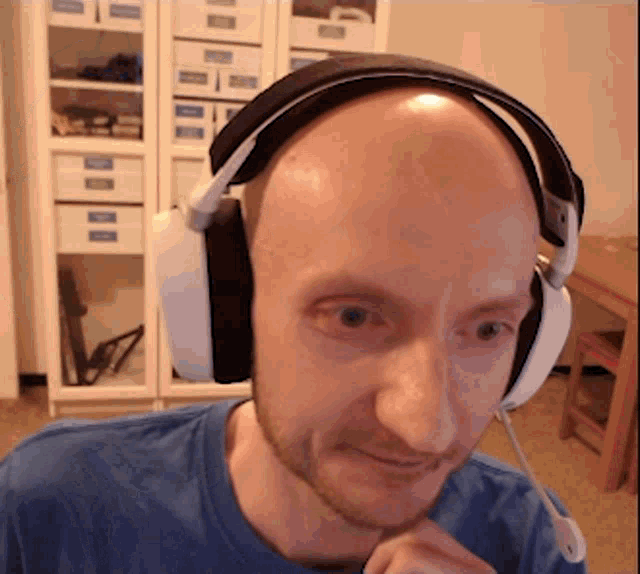 a bald man wearing headphones and a microphone