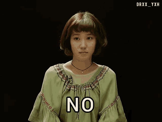 a woman in a green dress says " no "