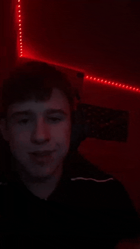 a young man wearing headphones is giving the peace sign