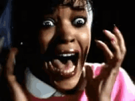 a close up of a woman with her mouth open