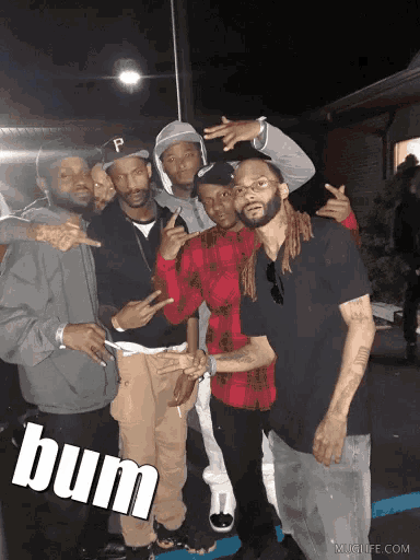 a group of men posing for a picture with the word bum on the bottom right corner