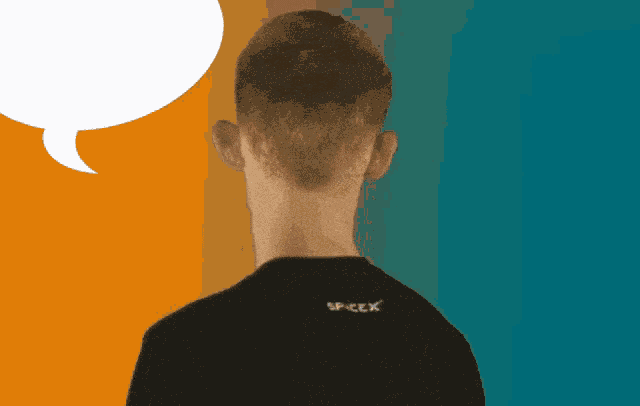 a man wearing a black shirt that says spacex