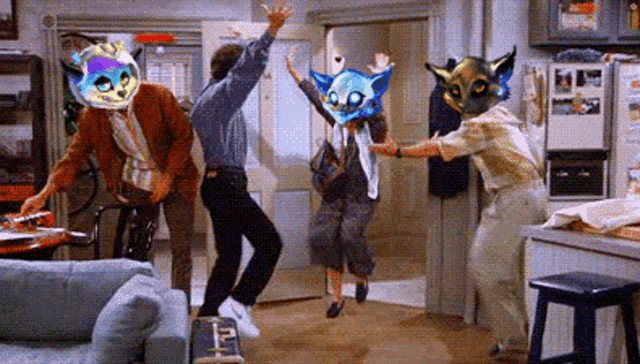 a group of people are dancing in a living room with masks on their heads .
