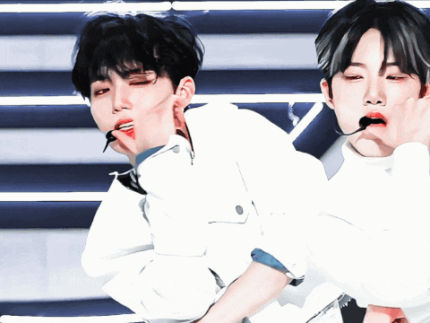 a man with a microphone in his mouth is dancing with another man