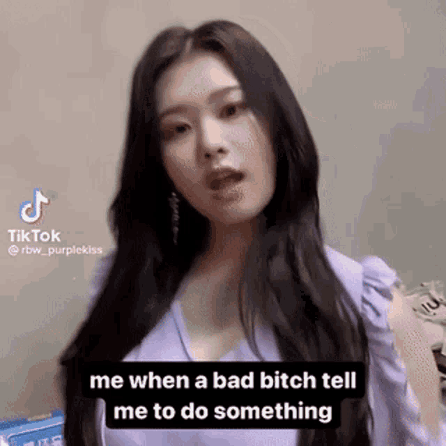 a woman in a purple shirt is making a funny face while talking on a tiktok video .