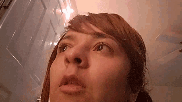 a close up of a woman 's face with a light behind her