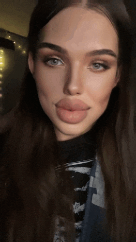 a close up of a woman 's face with a t-shirt that says t on it
