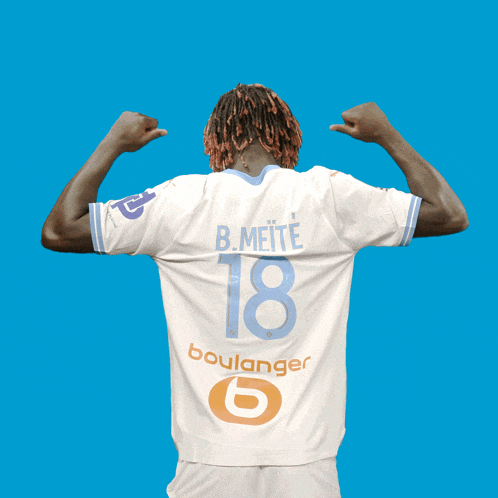 a soccer player wearing a white jersey with the number 18 on it