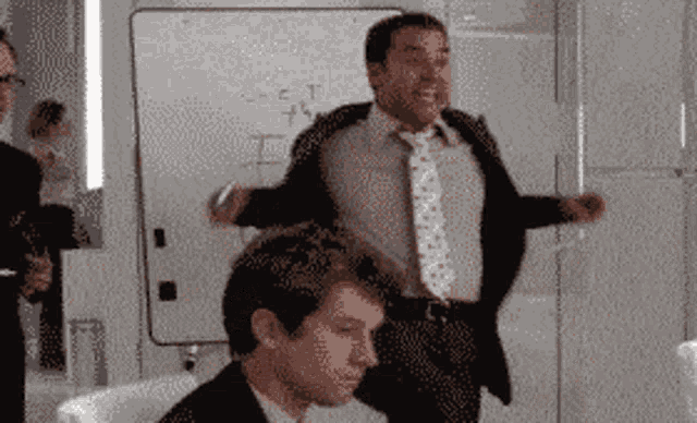 a man in a suit and tie stands in front of a white board that says " s = c = t " on it