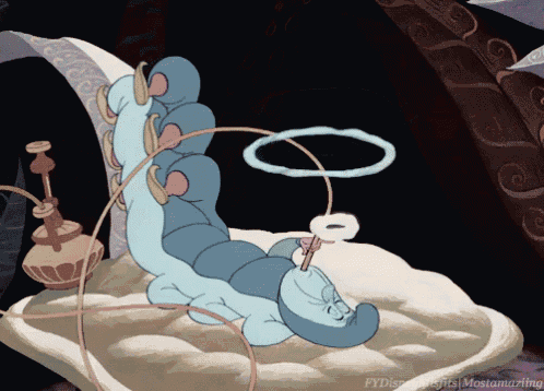 a cartoon caterpillar from alice in wonderland is laying on a pillow