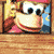 a picture of donkey kong on a wooden table with a blurred background .