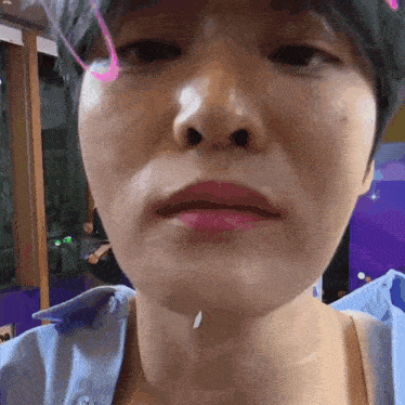 a close up of a person 's face with a pink lipstick on it .