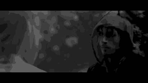 a black and white photo of a man wearing a hoodie with the words # indicception behind him