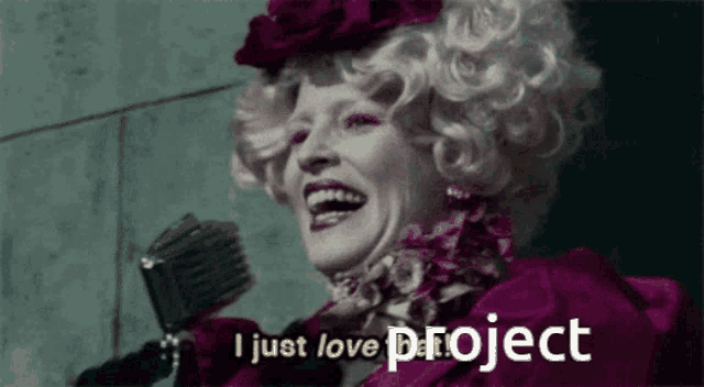 a woman in a pink dress is holding a microphone and says i just love project