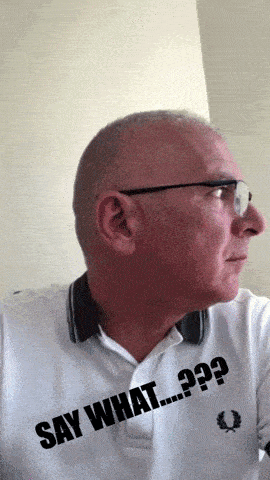 a man wearing glasses and a white shirt that says say what on it