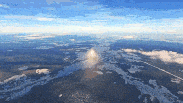 an aerial view of a mountain surrounded by water