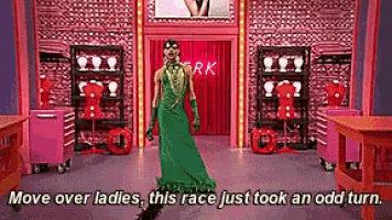 a man in a green dress is standing in front of a sign that says rk