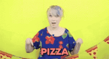 a woman is holding a slice of pizza in front of a string of pizza slices .