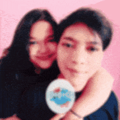a blurry picture of a man and a woman hugging