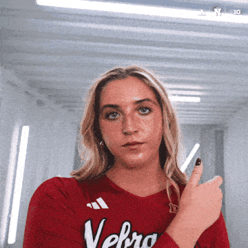 a woman wearing a red shirt with velbro on it