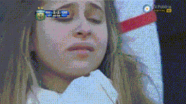 a woman is crying in front of a tv screen that says ' tv publica ' at the top