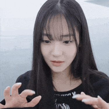 a girl with long black hair is wearing a black t-shirt with the word jivy on it