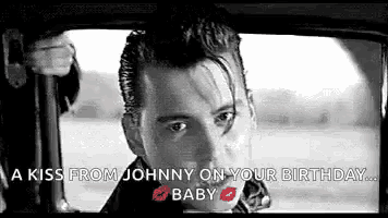 a black and white photo of johnny depp sitting in a car .