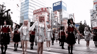 a group of people are dancing in front of a building that says aoki