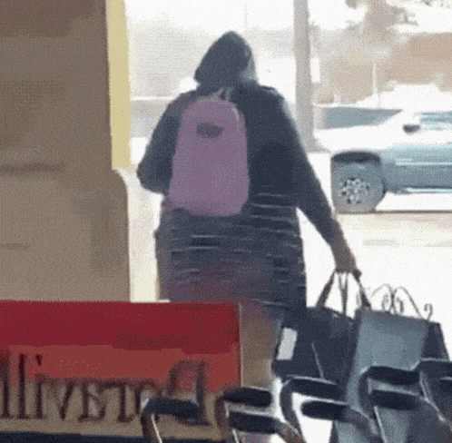 a person walking in front of a sign that says liver on it