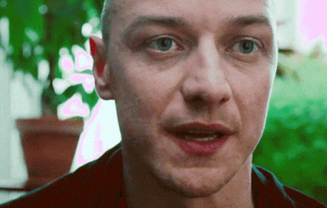 a close up of a man 's face with a red shirt on